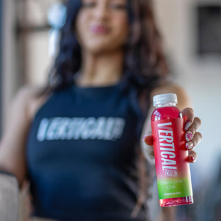 Picture of person holding vertical protein water bottle