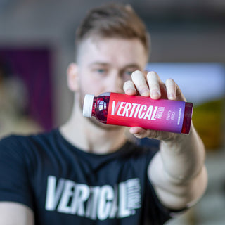 Picture of person holding vertical protein water bottle