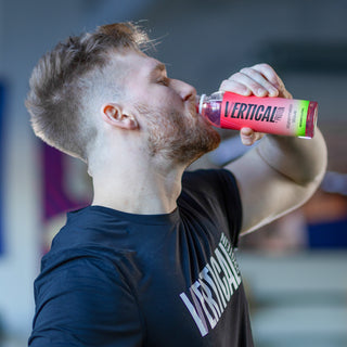 Picture of person drinking vertical protein water bottle